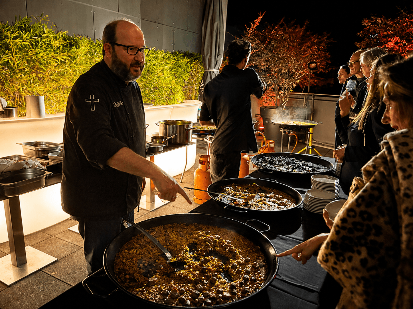 Master Chef Carlos Ripoll serving live paella at an elegant evening event